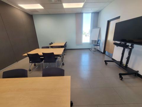 View of Community Room with Tables, chairs and portable monitor