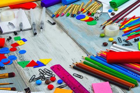 A colorful photo of various art supplies and school supplies. 