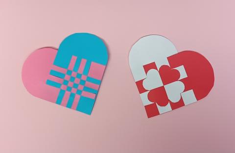 Two woven heart examples. One is blue and pink, and the other is red and white.