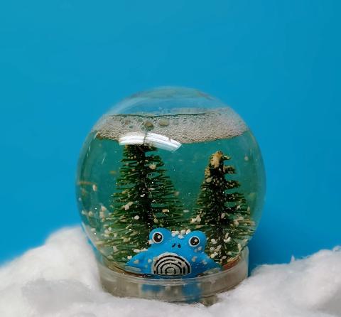 poliwhirl toy in a snow globe