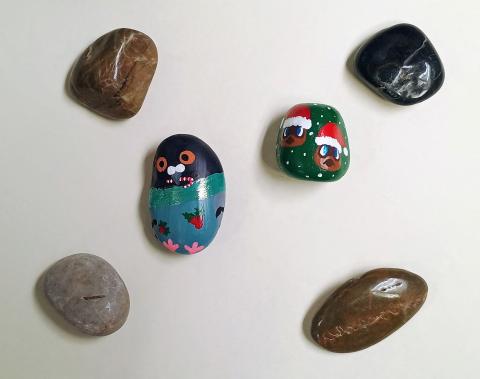 A rock painted like a pigeon and another rock has Animal Crossing characters