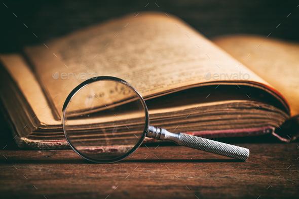 Picture of book and magnifying glass.