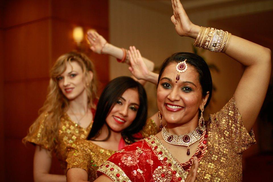 Three dancers in traditional Indian dress