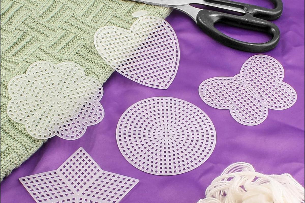 Image of white cross stitch mesh shapes over a purple background.