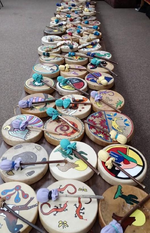 A photo of colorful Native American drums lined up.