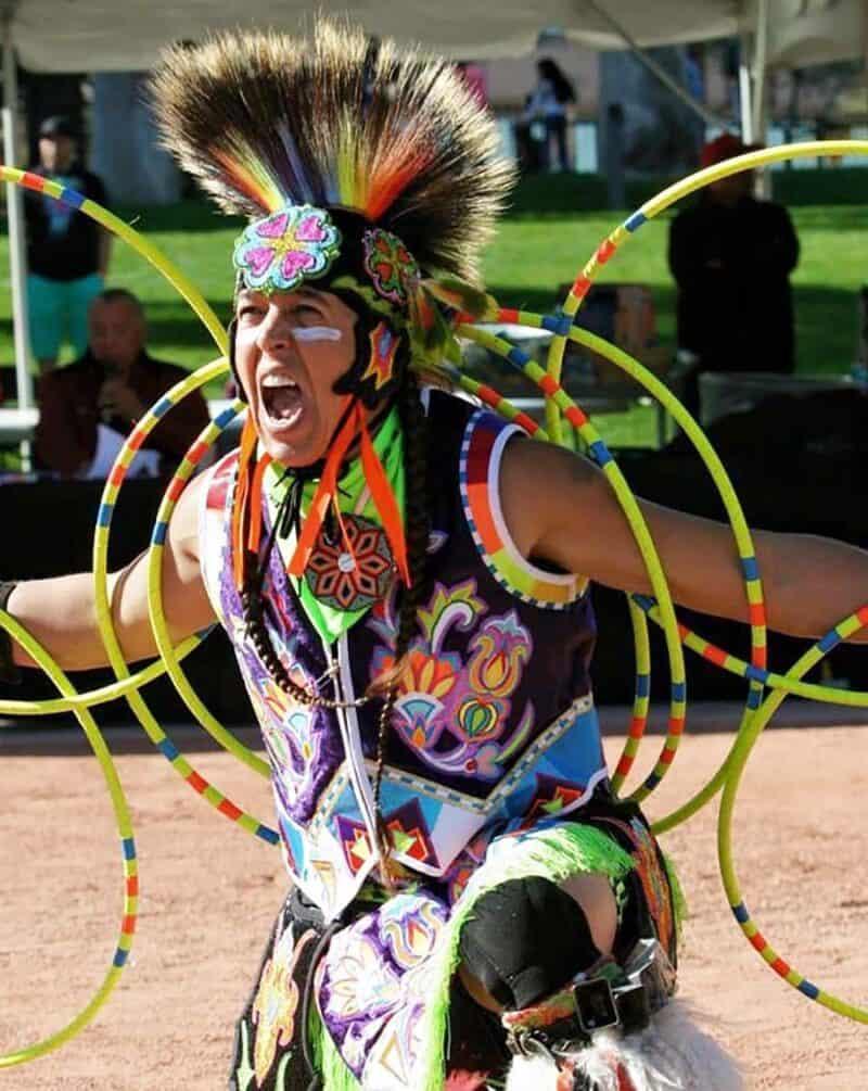 A photo of a hoop dancer performing.