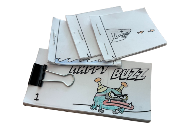 flipbooks stacked, doodle of great white shark on top