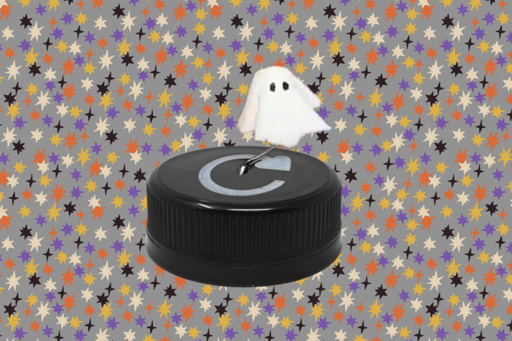 small ghost mounted on a plastic bottle cap