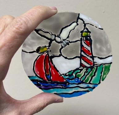 sailboat and lighthouse in faux stained glass